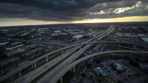 Dronelapse Hyperlapse over busy highway traffic as storm moves in during sunset Video stock 102145056