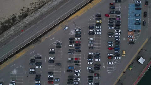 Drone's aerial view reveals a densely packed parking lot filled with cars Stock Footage 258558252