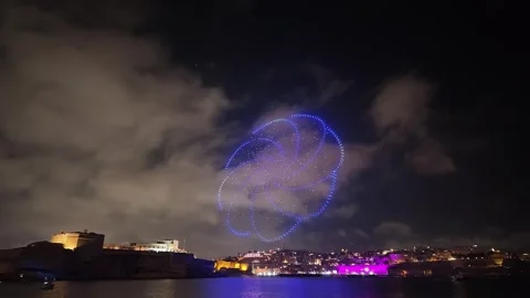 Drones and fireworks form colorful patterns over Malta's Grand Harbour at night Stock Footage 338037283