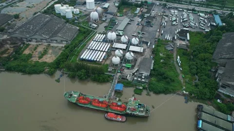 Drones are flying over a gas tanker docked in port Stock Footage 210774093