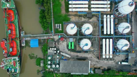 Drones are flying over a gas tanker docked in port Stock Footage 210775737