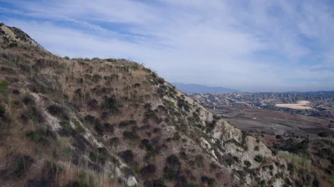 Drone's Ascent Over Hillside Unveils Vast Landfill Horizon Stock Footage 250383570