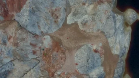 Drone's camera rotates and fly at the violinist girl lying on ground to the bott Stock Footage 221031698