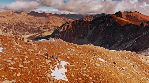 Drones capture hikers exploring the breathtaking Pyrenees in Spain Stock Footage 303624071