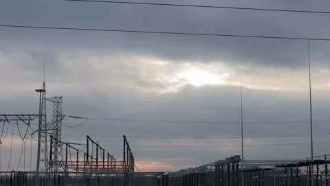 A drone's eye captures the silhouette of a transformer station against a vi.. Video stock 259049086
