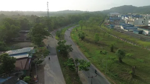 Drone's eye view of a thriving industrial zone alongside a winding road, su.. Video stock 339040103