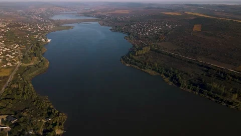 The drone's flight over a beautiful lake with villages and farmland Stock Footage 166064213