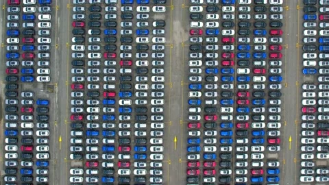 Drones flying above factory parking lot, new cars unsold Stock Footage 210793685
