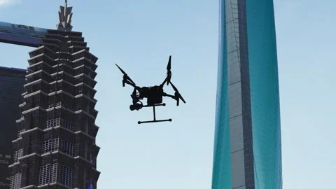 Drones flying between city office buildings Stock Footage 322851653