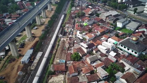 Drone's Glimpse: Local Bandung Raya Train, Passengers Alighting and Boarding Stockbeeldmateriaal 244048052