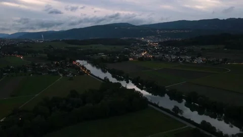 Drones hyperlapse pullback from the city of Biel and the river Aare at dusk Stock Footage 140424618