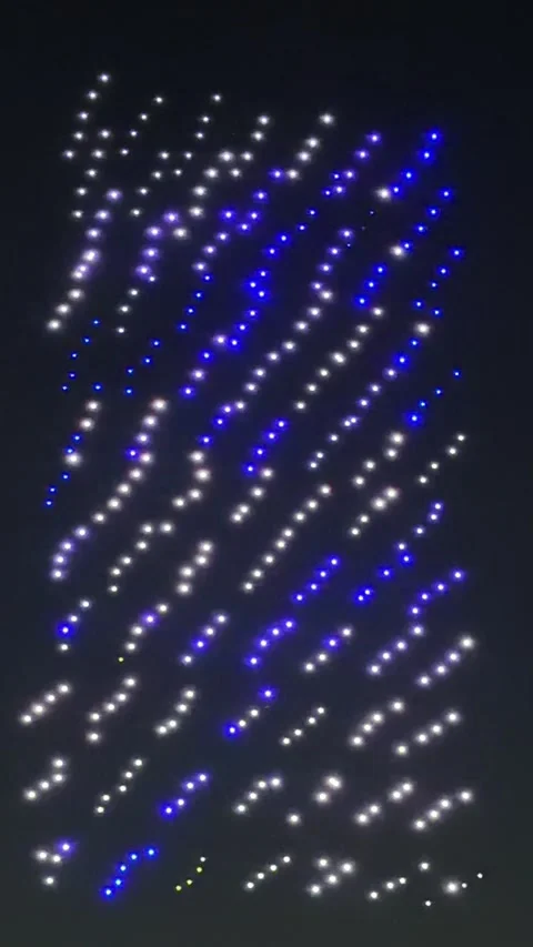 Drones light up the night sky in rows of blue and white Stock Footage 339215154