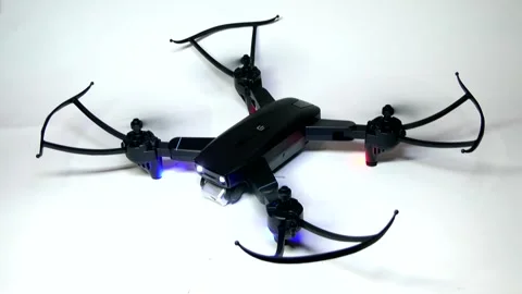 The drone's lights flash, then the propellers start and stop. Stock-Footage 342257064