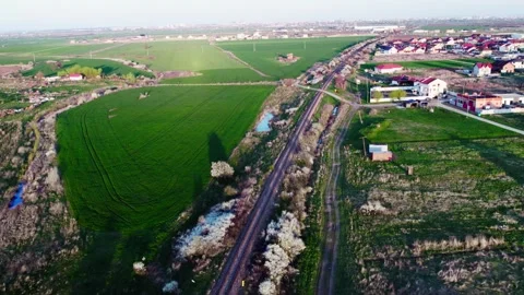 A drone's perspective of railways next to a village Video stock 272993687