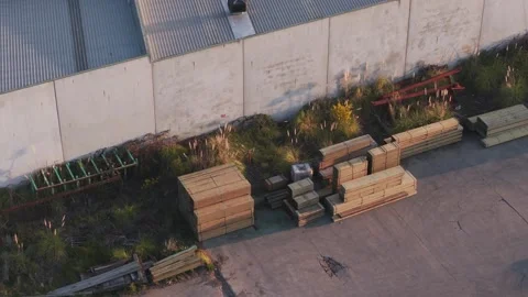Drone's shadow moving across an industrial warehouse yard 库存影片 346371615