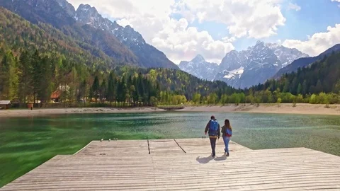 Drones shot of couple who is walking to a wonderful view of Slovenian Alps Video stock 90194101