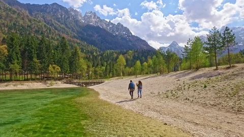 Drones shot of couple who is walking to a wonderful view of Slovenian Alps Video stock 90199136
