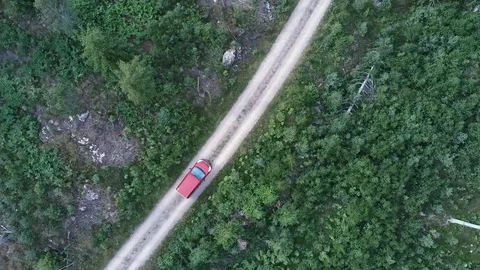 Drones shot from a moving car on a forest road Stock Footage 129638993
