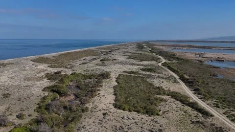 A Drone's Sweeping Perspective of a Slender Barrier Dividing a Pristine Stock Footage 314187253
