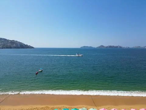 Drone's View of Acapulco Beach: Partial Shoreline, Sky, and a Boat in the Sea Stock Photos