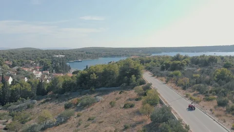 Droneshot of a Four-Wheeler driving down road Stock Footage 97743647