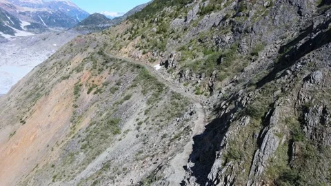 Droneshot of a shallow mountain Road at the Salmon Glacier in Hyder Stock Footage 221774997