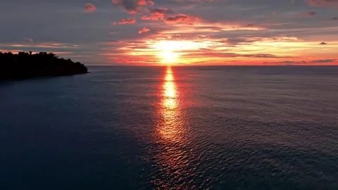 Droneshot Tilt up Sunset on sea with cloudy Sky Stock Footage 296880552