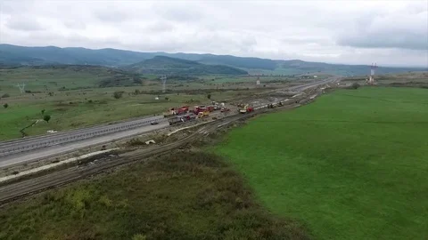 Droning over a construction site on a motorway where the gravel transport veh Stock Footage 80262847