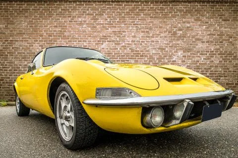 DRONTEN/NETHERLANDS-MAY 22, 2016: Low angle view of a yellow Opel GT at a cla Stock Photos