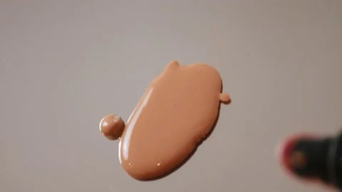 A drop of beige liquid foundation falls on the mirror. Stock Footage 149310369