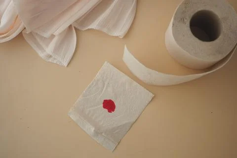 A drop of blood is on a tissue paper . Stock Photos
