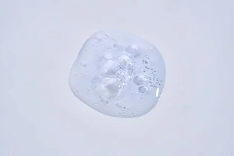 A drop of blue serum with bubbles. Stock Photos