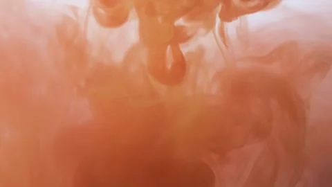 Drop brown ink on orange ink paint in water  Stock Footage 144914983