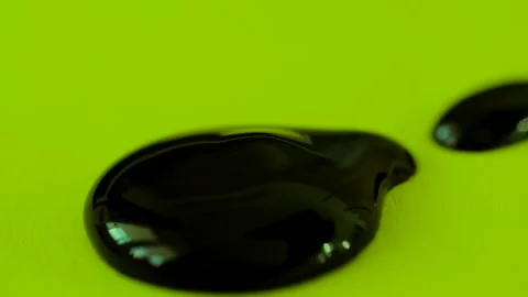 A drop of brown paint on a green background Stock-Footage 102736361