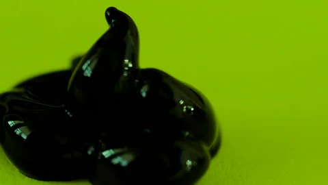 A drop of brown paint on a green background Stock Footage 102736882