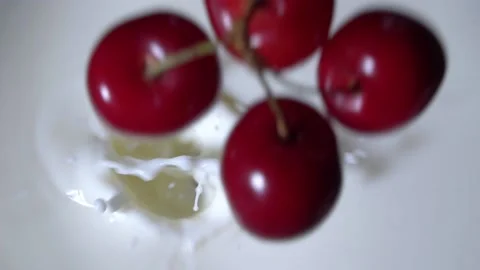 Drop of cherry in yogurt mossy seed close-up Stock Footage 133622482