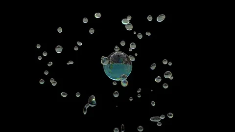 Drop of clear water explodes forming many small drops on black Stock Footage 87885727