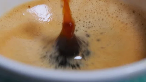 Drop of Coffee in a Cup Macro View Stock Footage 145972679