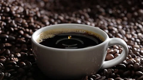 Drop of coffee falling into coffee cup. Slow motion. Stock Footage 177563603