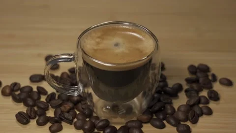 A drop of coffee falling into cup of espresso in slow motion Stock Footage 217898379