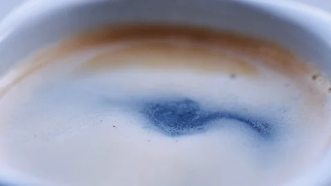 Drop of coffee falls into the filled cup 스톡 동영상 105650153
