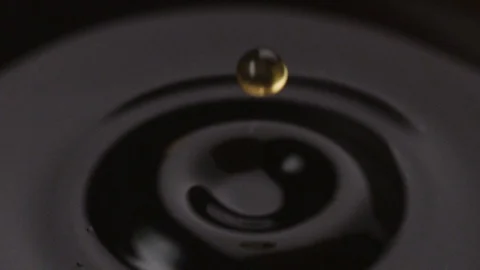 Drop of coffee falls into a mug close up Stock-Footage 86265326