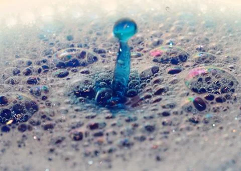 Drop of colored liquid Stock Photos