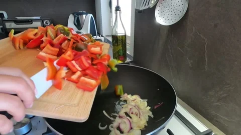 Drop colored peppers into the pan Stock Footage 145881142