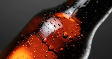 Drop of condensate drains on beer bottle glass Stock Footage 94728217