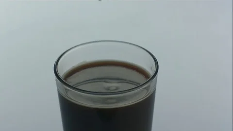 Drop of Cream Splashes Into Glass of Nitro Cold Brew Coffee in Slow Motion Stock Footage 75118293