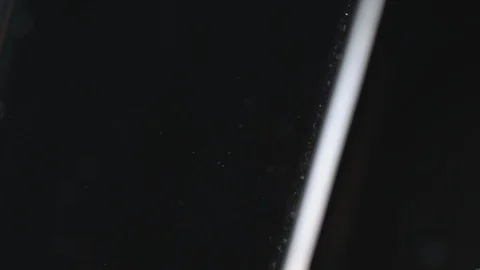 Drop creating a splash and ripples after falling into the water in slow motion Stock Footage 107948637