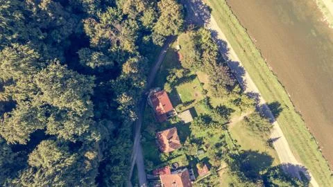Drop down view of houses next to a forest. Stock Photos