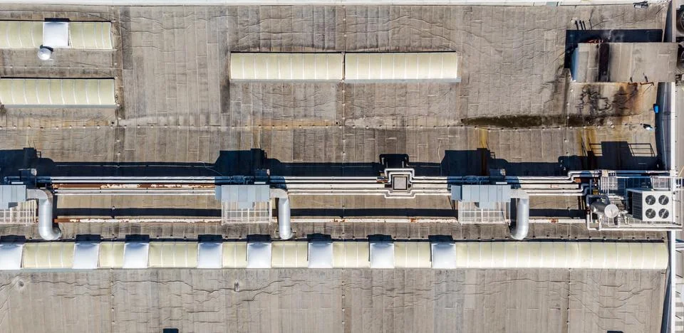 Drop down view of HVAC system with cooling pipes running along the roof. Stock Photos