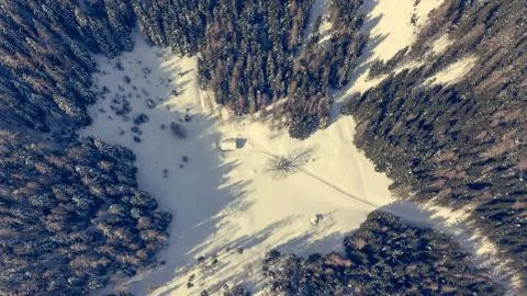 Drop down view of road going through winter forest. Stock Photos